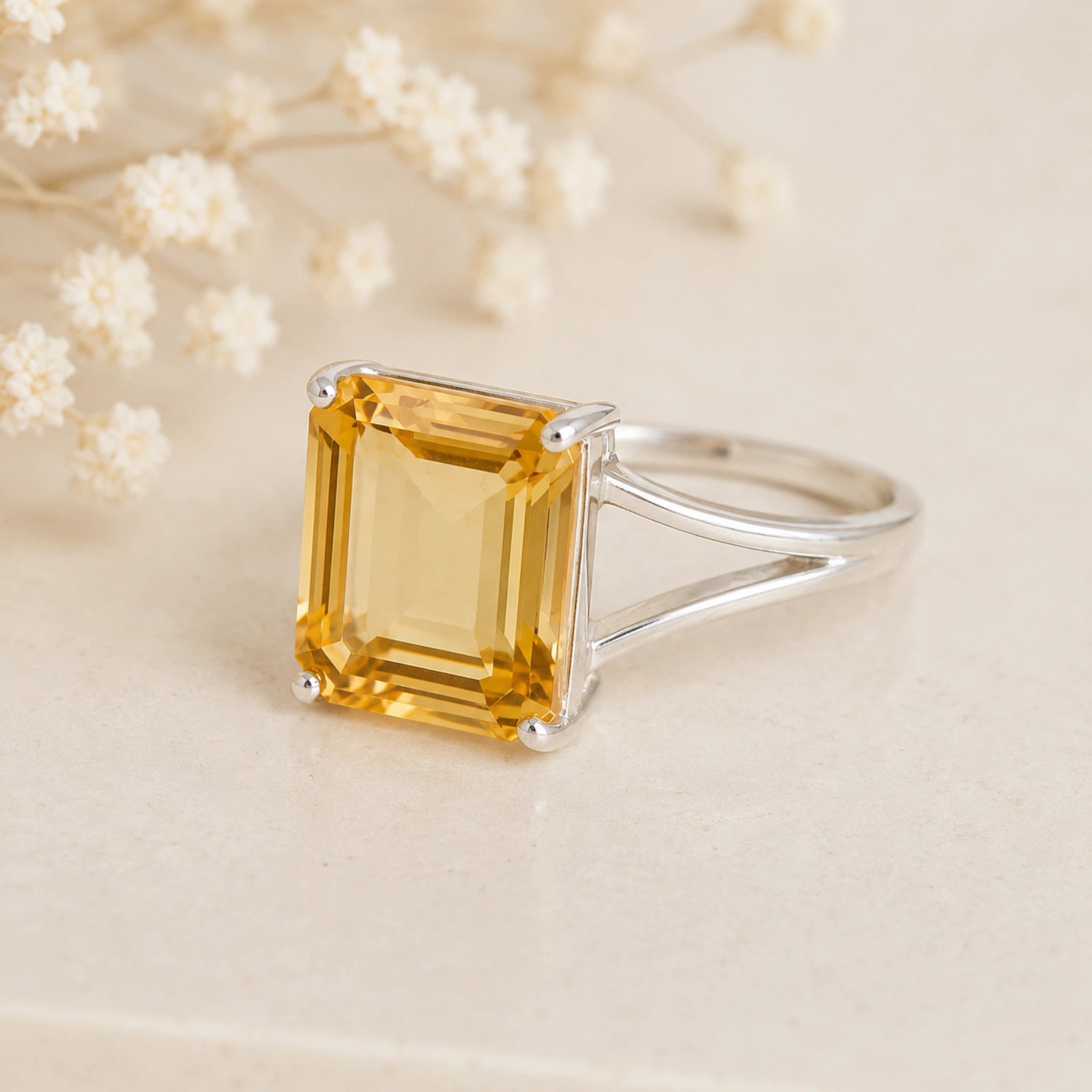 Sterling Silver Statement Style Ring wtih large emerald-cut claw set natural citrine on a light background