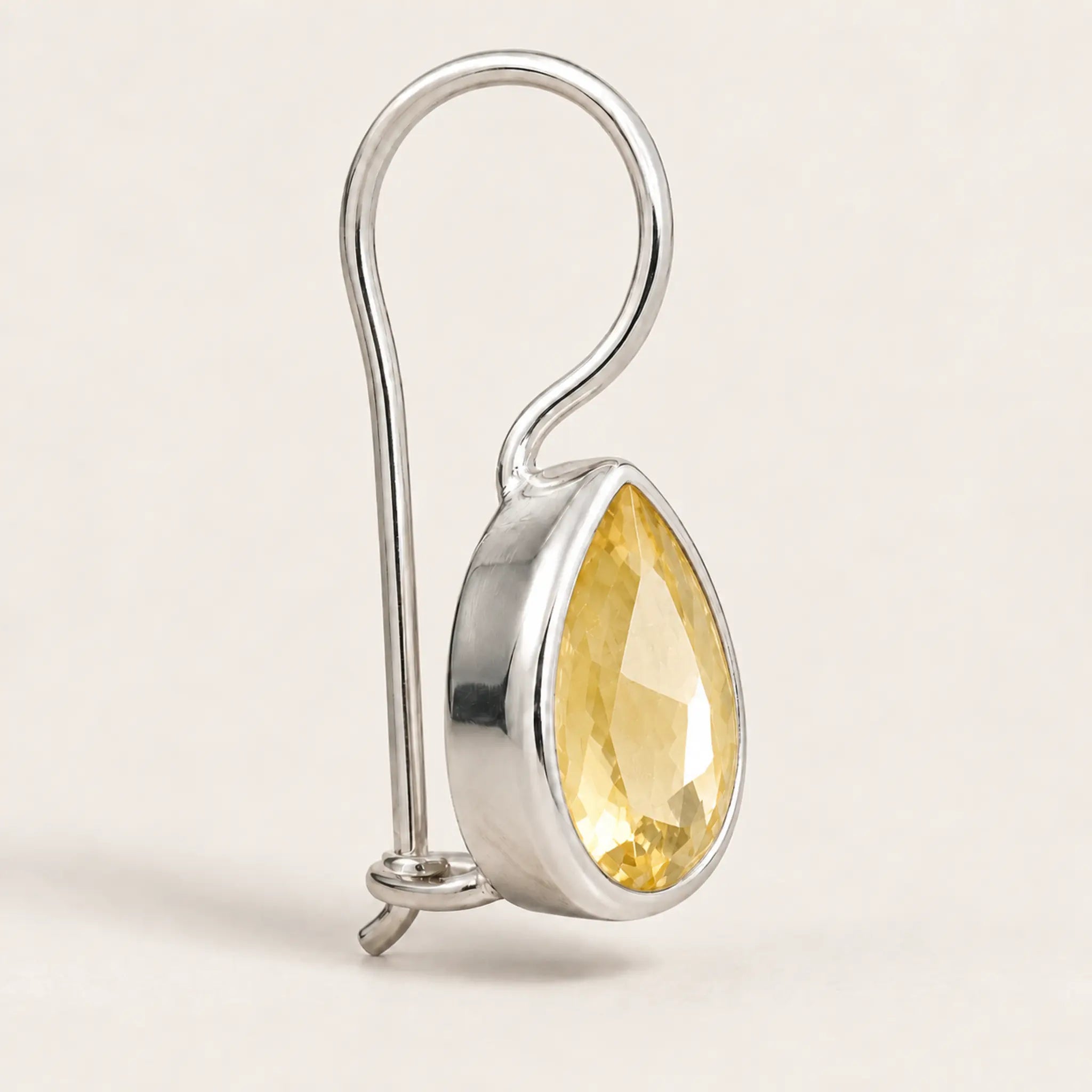 Side view of sterling silver natural citrine teardrop hook earring