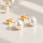 Gold plated freshwater pearl earrings side view showing the gold posts and butterfly backs