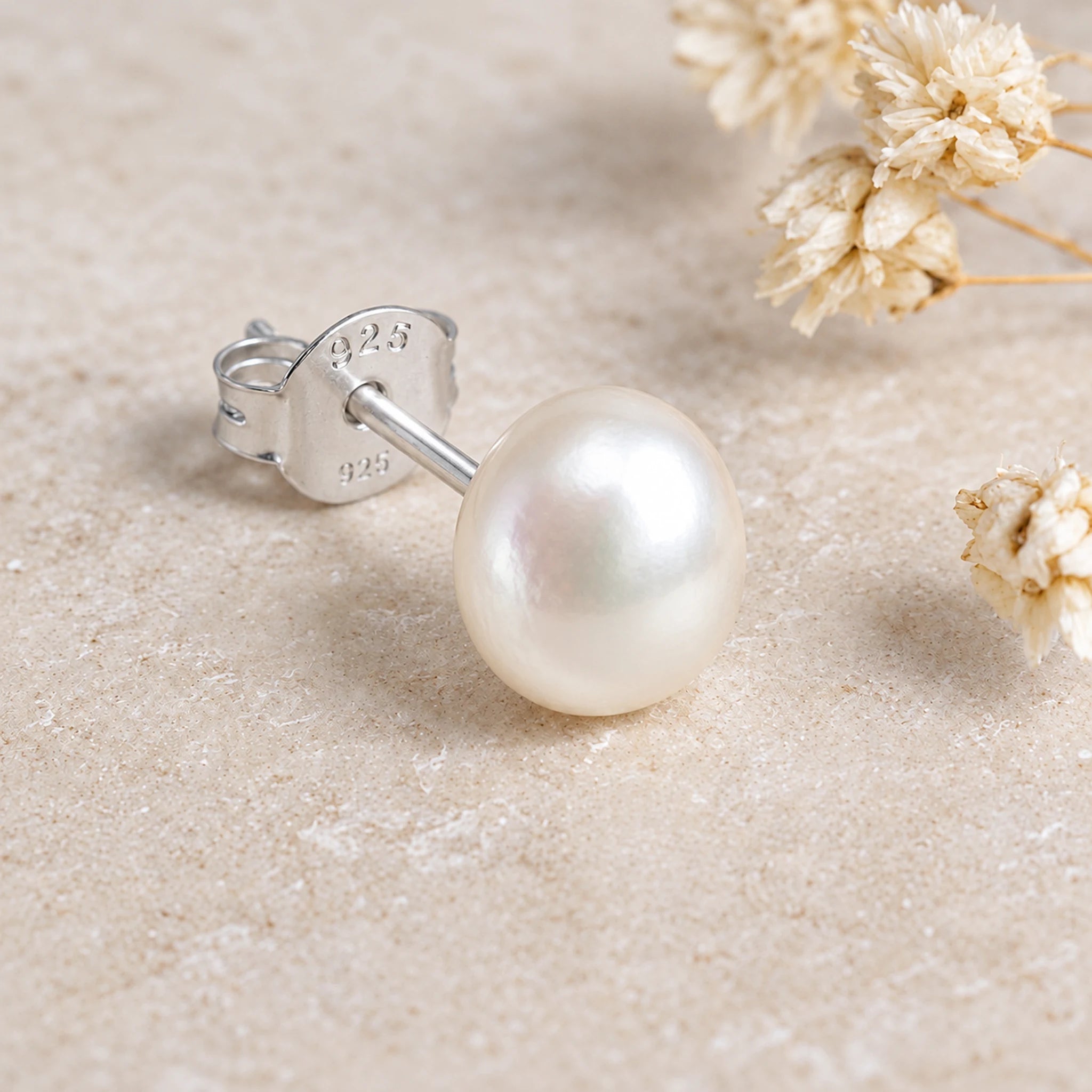 Sterling silver freshwater pearl stud side view showing the post and butterfly back on stone