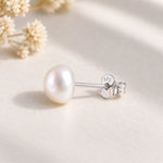 Sterling silver freshwater pearl stud close-up showing the post stamped 925 and butterfly back