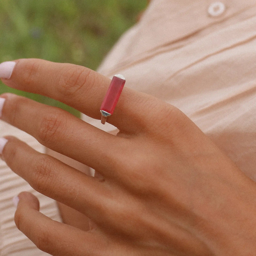 woman wearing a sterling silver ring with a rectangular pink jade stone