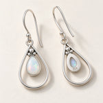 Front and back of opal teardrop French hook earrings, showing the 925 stamp on the back, on a cream background