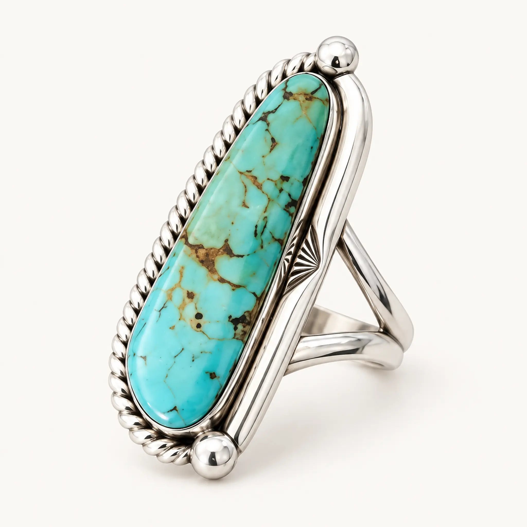 A sterling silver ring featuring a large, polished turquoise stone with natural brown veining, set in a Southwestern-style twisted bezel and triangular band design, shown on a clean off-white background.