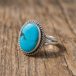 side image of a Sterling Silver  Turquoise Ring handcrafted by Navajo Artisans with an oval natural Kingman Turquoise stone