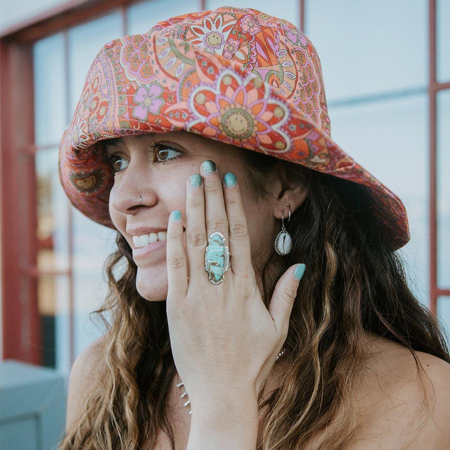 Woman with funky hat wearing Navajo Sterling Silver Turquoise Ring - Native American Jewelry - womens turquoise jewellery