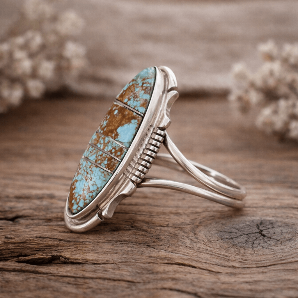 Silver ring with turquoise stone on a wooden surface