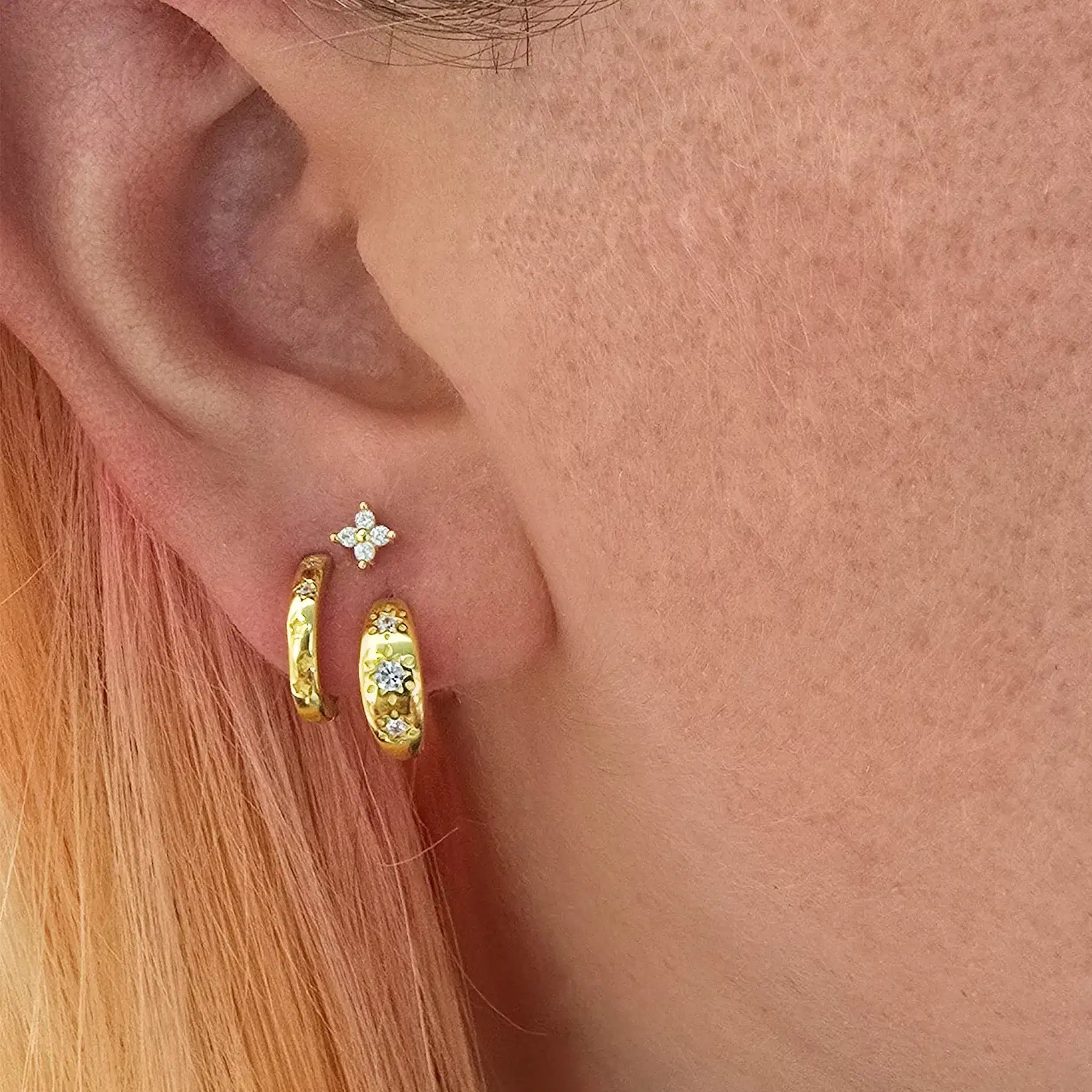 gold earrings set being worn