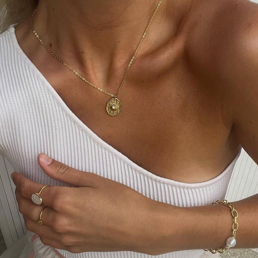 Woman wearing a white top and gold waterproof jewellery - womens gold necklace by Australian jewellery brand indie and harper