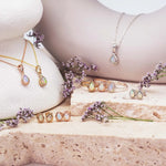 group shot of various october birthstone jewellery including opal necklaces, earrings and rings - indie and harper jewellery australia