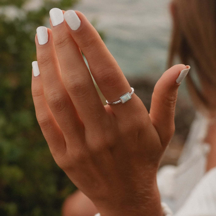 Woman’s hand wearing an Opal Ring - womens opal jewellery