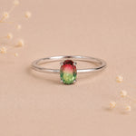 sterling silver oval watermelon tourmaline ring with green and pink colours on a light background