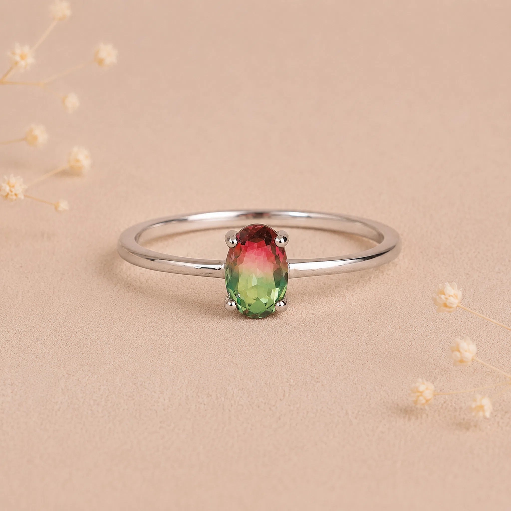 sterling silver oval watermelon tourmaline ring with green and pink colours on a light background