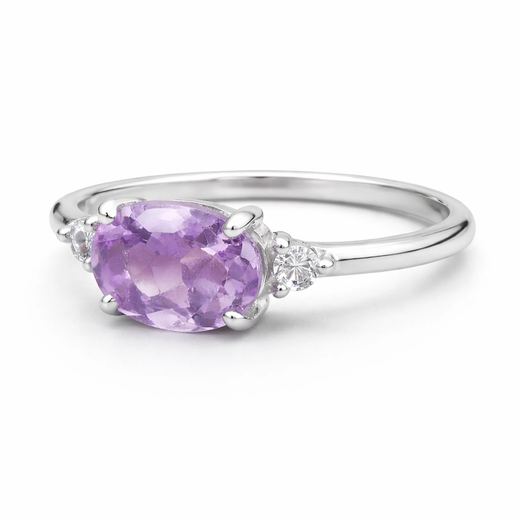 Silver ring with a purple pink amethyst and white topaz accent gemstones on a white background