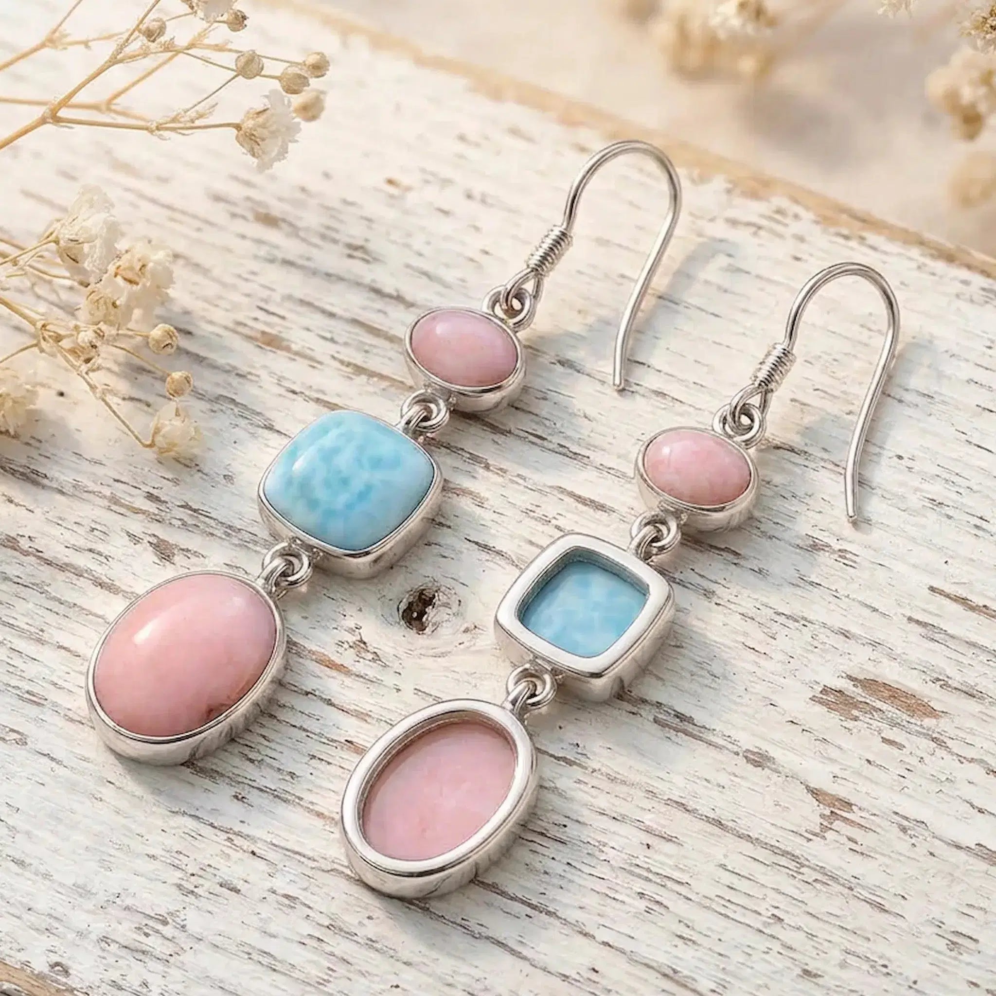 sterling silver french hook earrings with natural pink opal and larimar gemstones on rustic wooden background