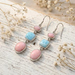 sterling silver french hook earrings with natural pink opal and larimar gemstones on rustic wooden background