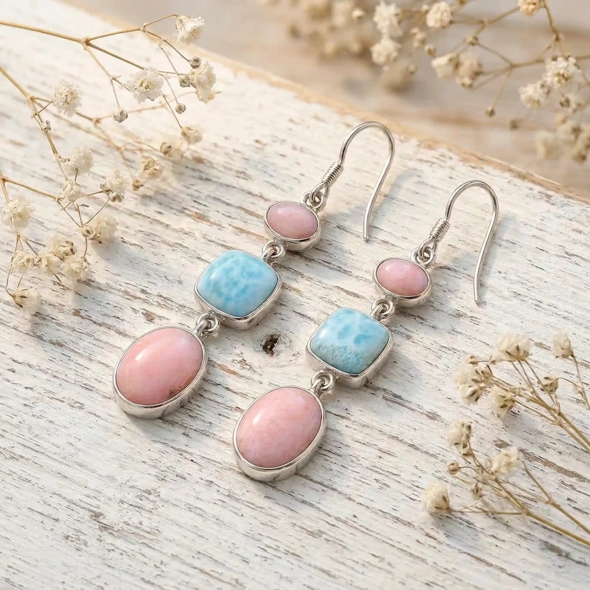 sterling silver french hook earrings with natural pink opal and larimar gemstones on rustic wooden background