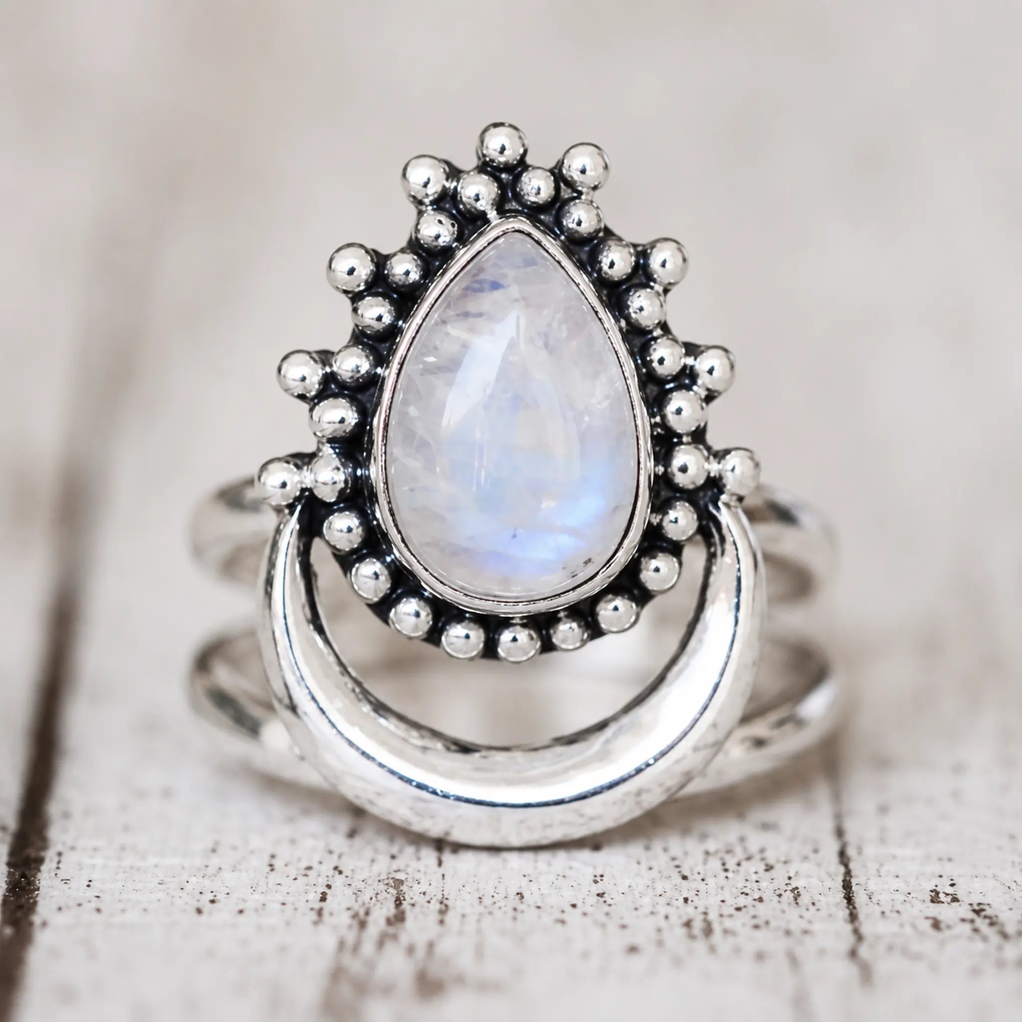 Rainbow moonstone crescent ring in polished sterling silver with beaded detailing