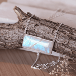 sterling silver Necklace with a rectangular rainbow moonstone pendant on a wooden branch