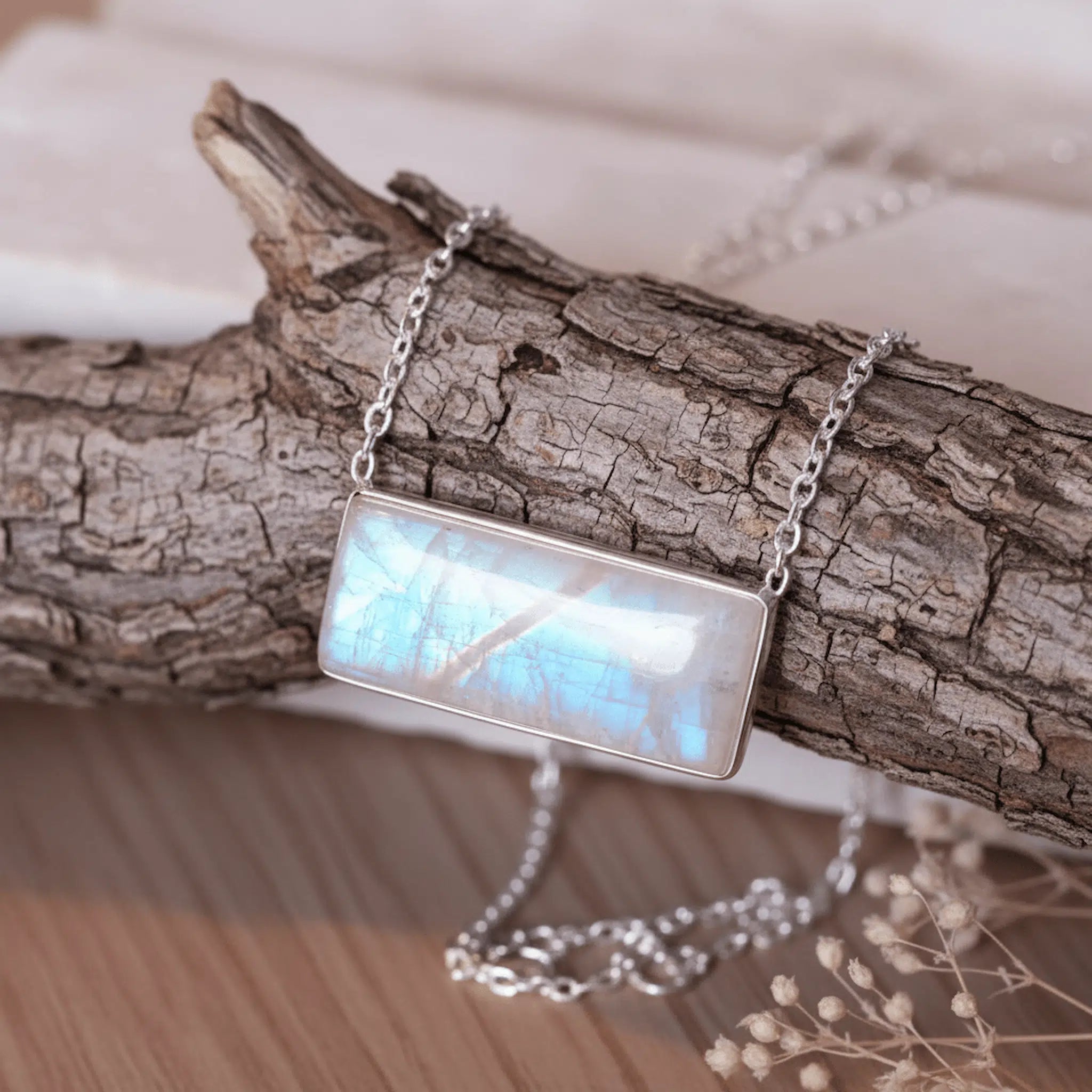 sterling silver Necklace with a rectangular rainbow moonstone pendant on a wooden branch