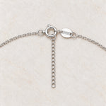Rainbow moonstone and pearl necklace spring ring clasp and 2 inch extender close-up on cream marble