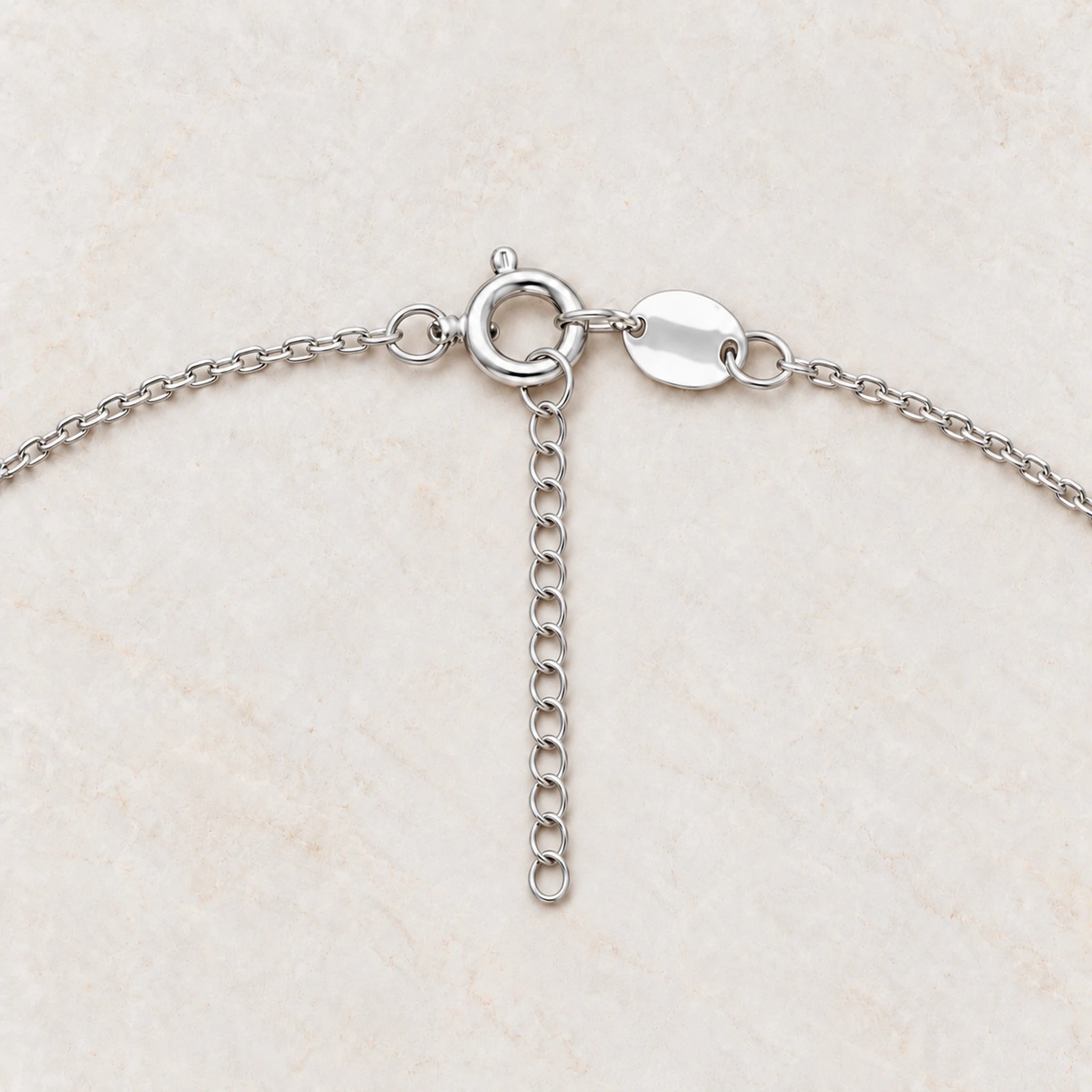 Rainbow moonstone and pearl necklace spring ring clasp and 2 inch extender close-up on cream marble