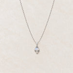 Rainbow moonstone and pearl necklace flat lay on cream marble showing the full fine sterling silver chain