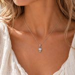 Rainbow moonstone and pearl necklace worn on a model, dainty oxidised sterling silver pendant on a fine chain