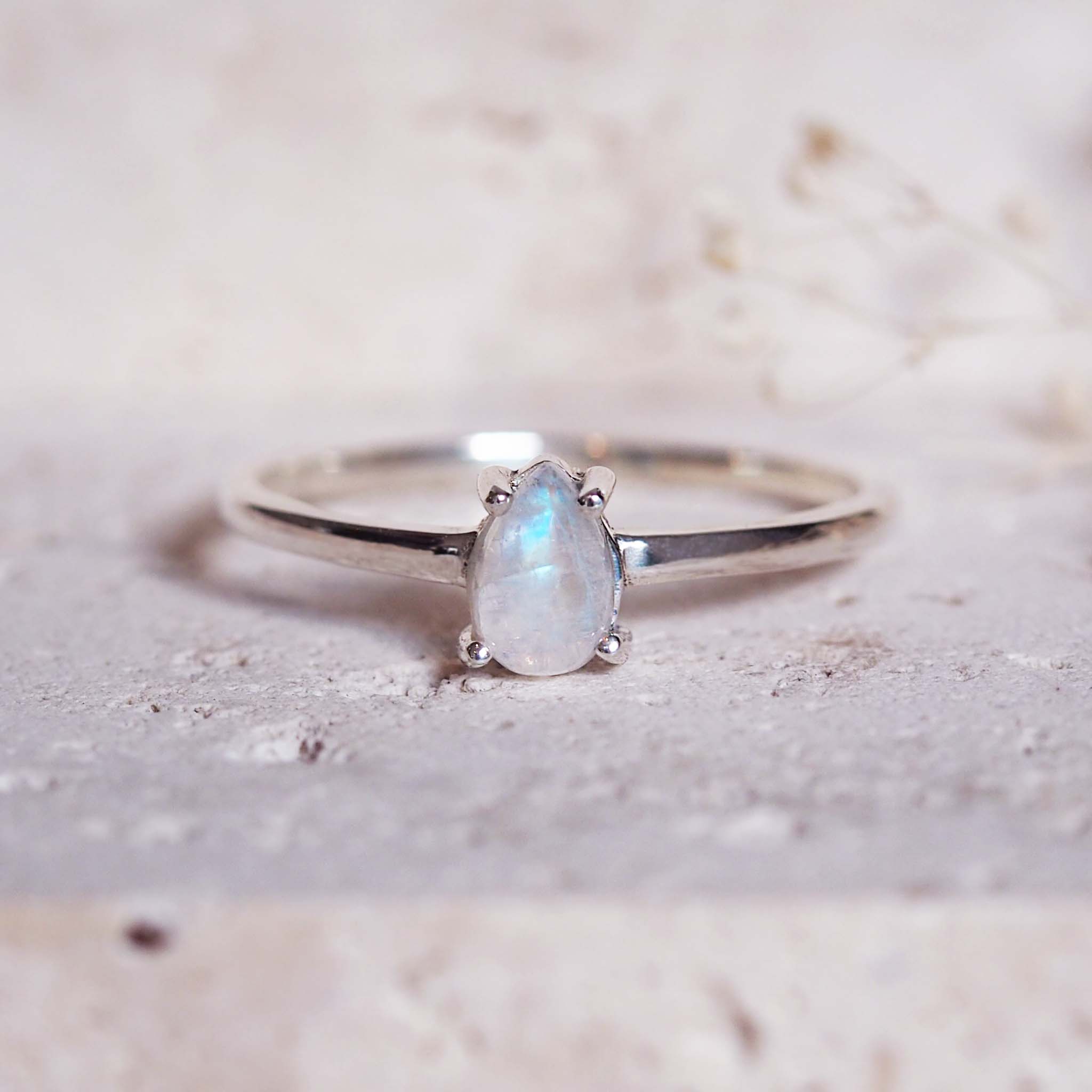 Silver ring with a moonstone on a light background