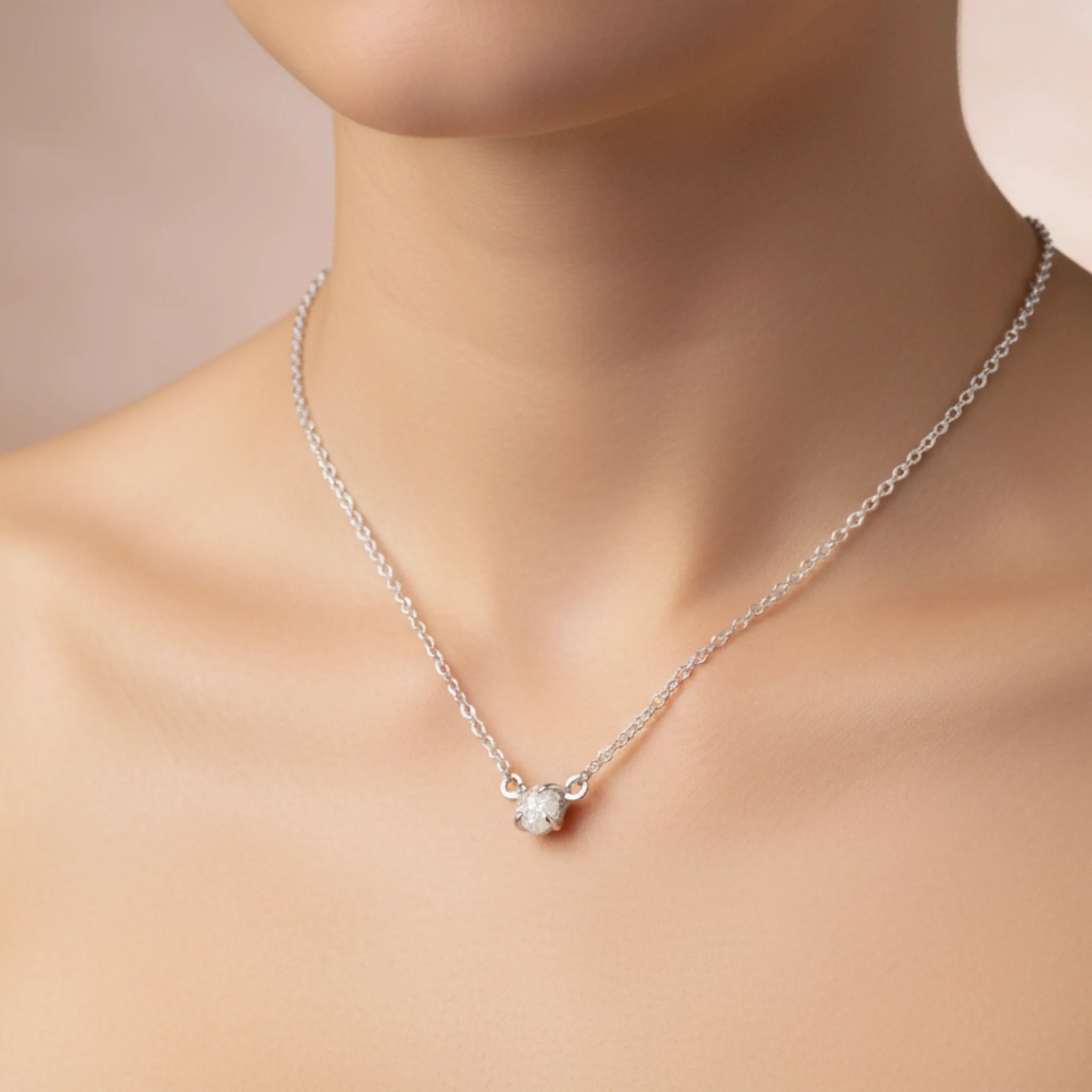 Sterling silver raw white diamond necklace being worn 