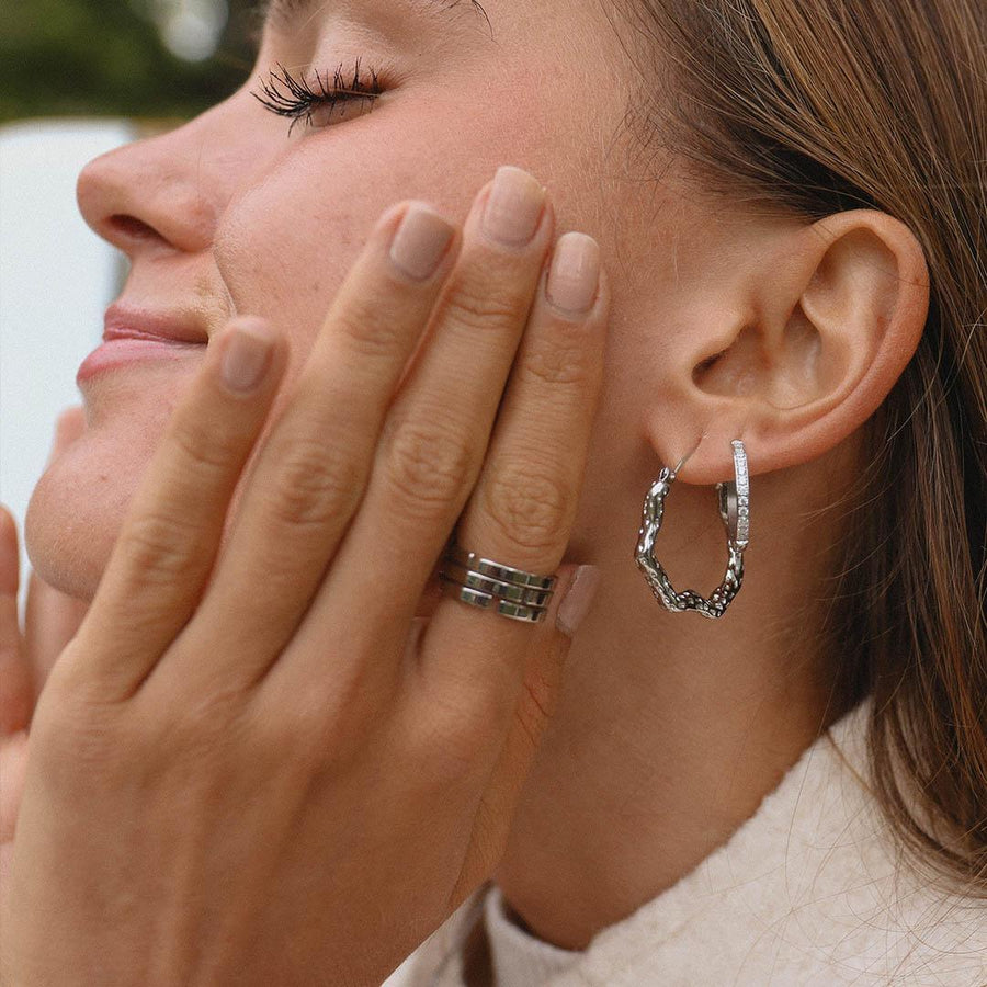 Woman wearing silver Hoop Earrings and silver ring - womens waterproof jewellery Australian jewellery brand 