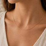 model wearing a minimalist 18k rose gold curb chain necklace