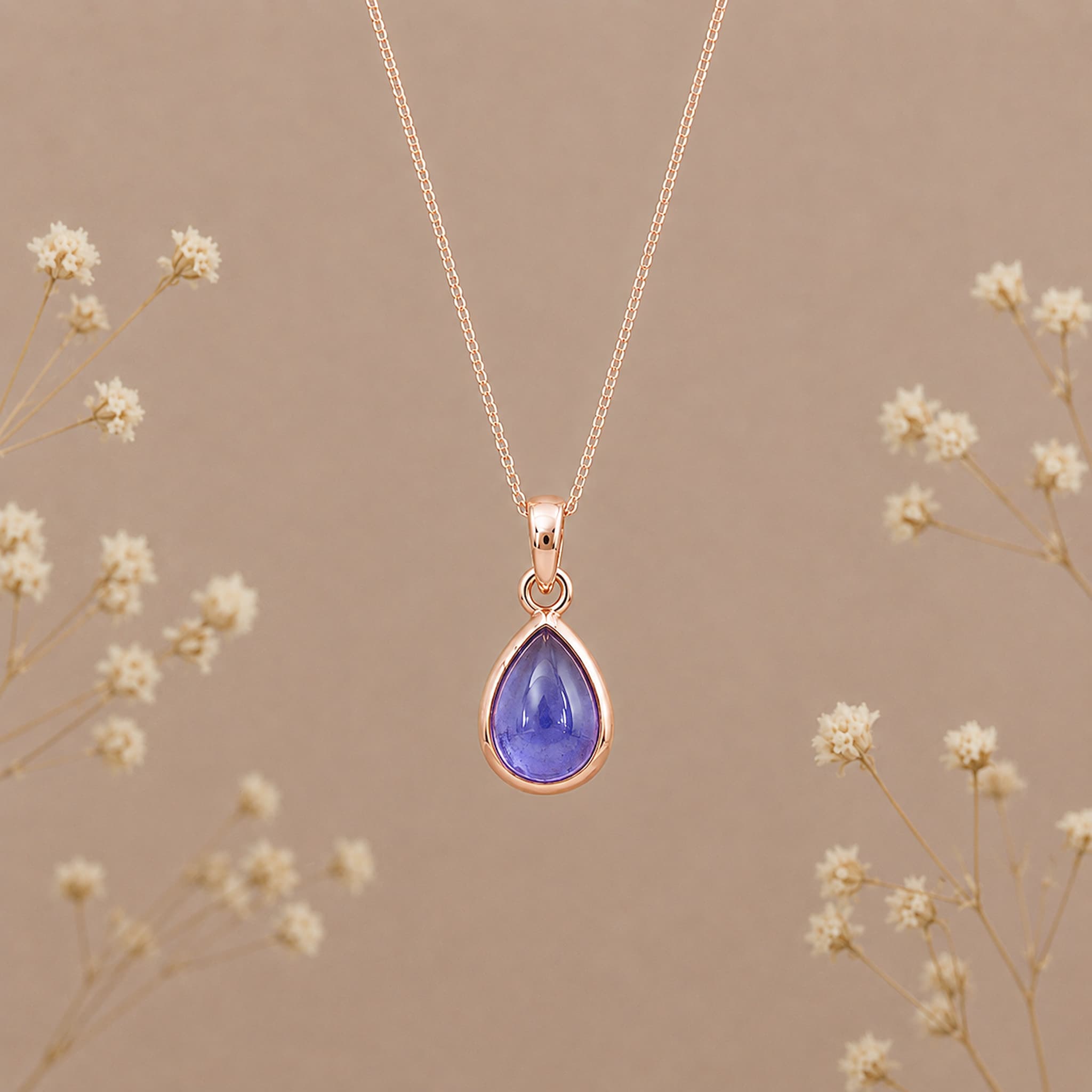 Indie and Harper December birthstone necklace with teardrop tanzanite pendant in rose-gold setting