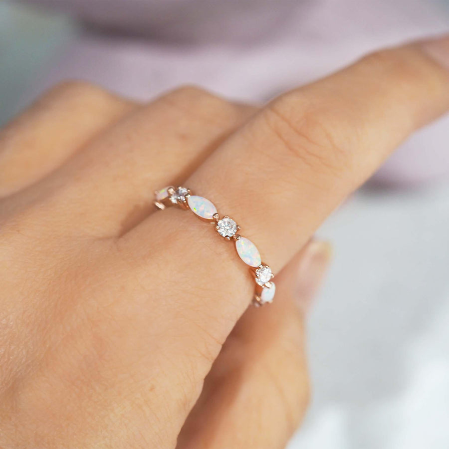 Woman’s hand wearing Rose Gold Ring with opals and cubic zirconias - opal jewellery - Australian jewellery brand