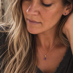 model wearing a rose gold february birthstone jewellery set including a natural amethyst pendant necklace and matching stud amethyst earrings