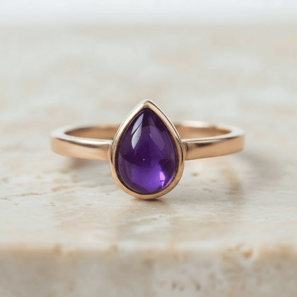 Rose gold February birthstone ring with pear-shaped natural amethyst gemstone as a meaningful birthstone jewellery gift for her