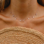 woman wearing rose gold necklace with dainty opal stones - rose gold jewellery by australian jewellery brands indie and harper