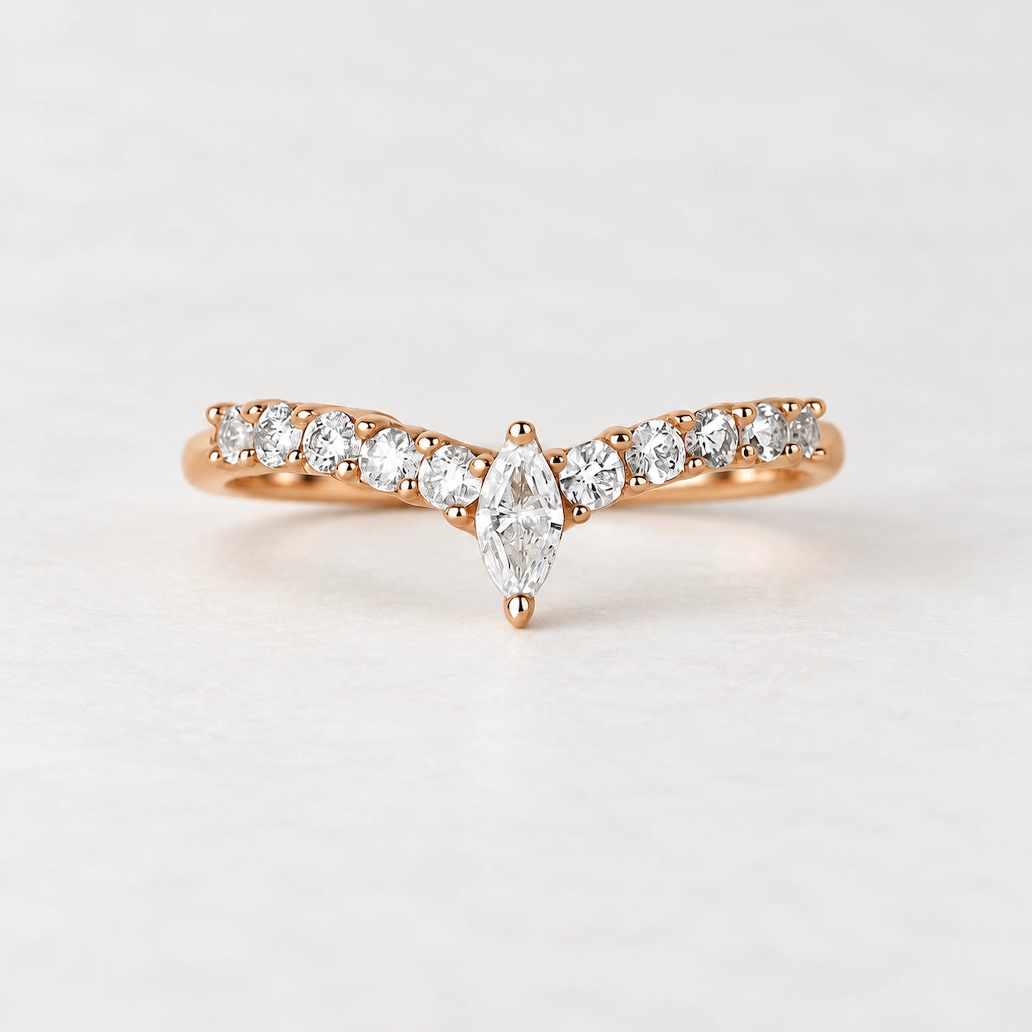 rose gold vermeil chevron ring with cubic zirconias on a light background