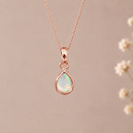 Rose gold October birthstone necklace with a teardrop natural opal pendant