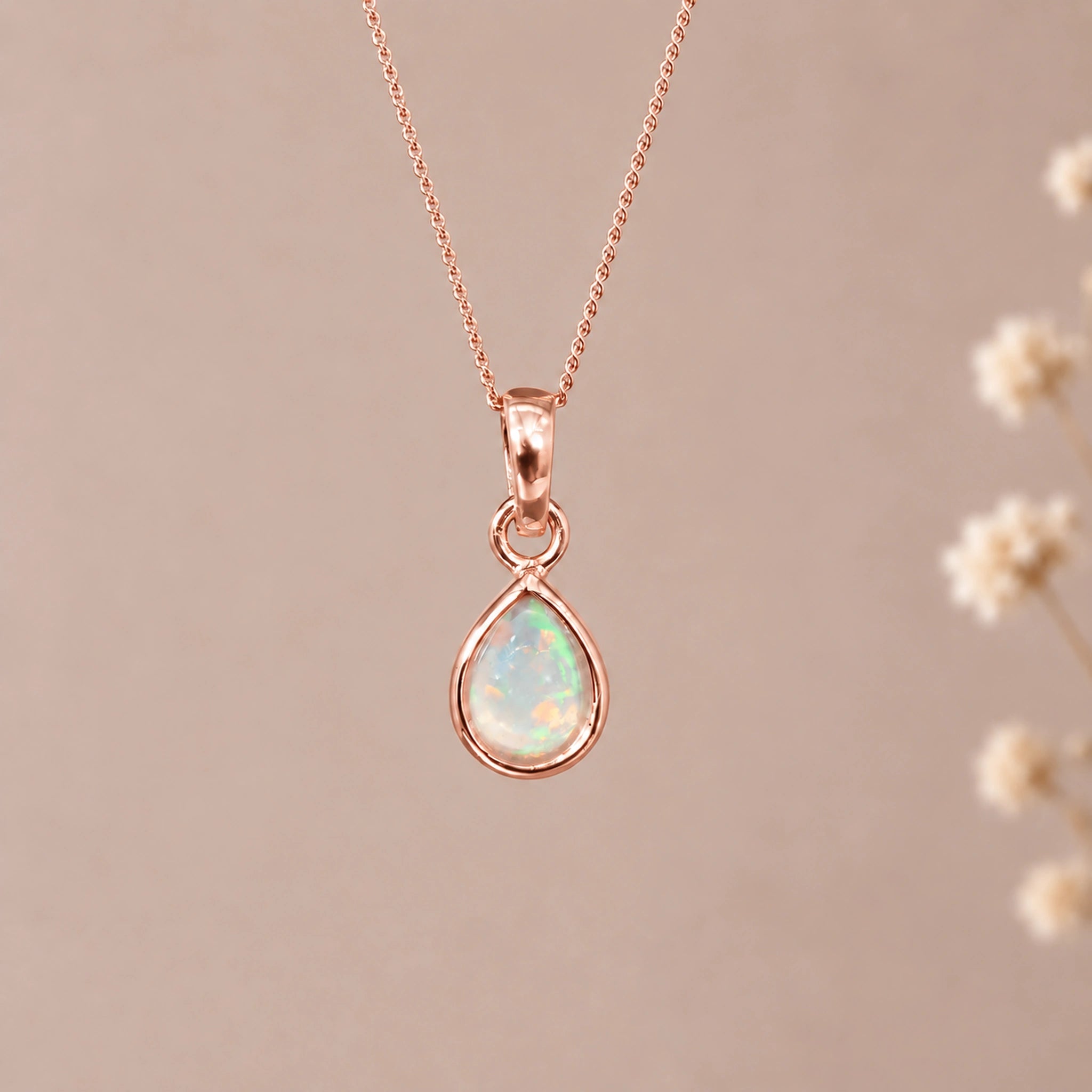 Rose gold October birthstone necklace with a teardrop natural opal pendant