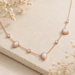 rose gold necklace with lab-grown white opals and CZs