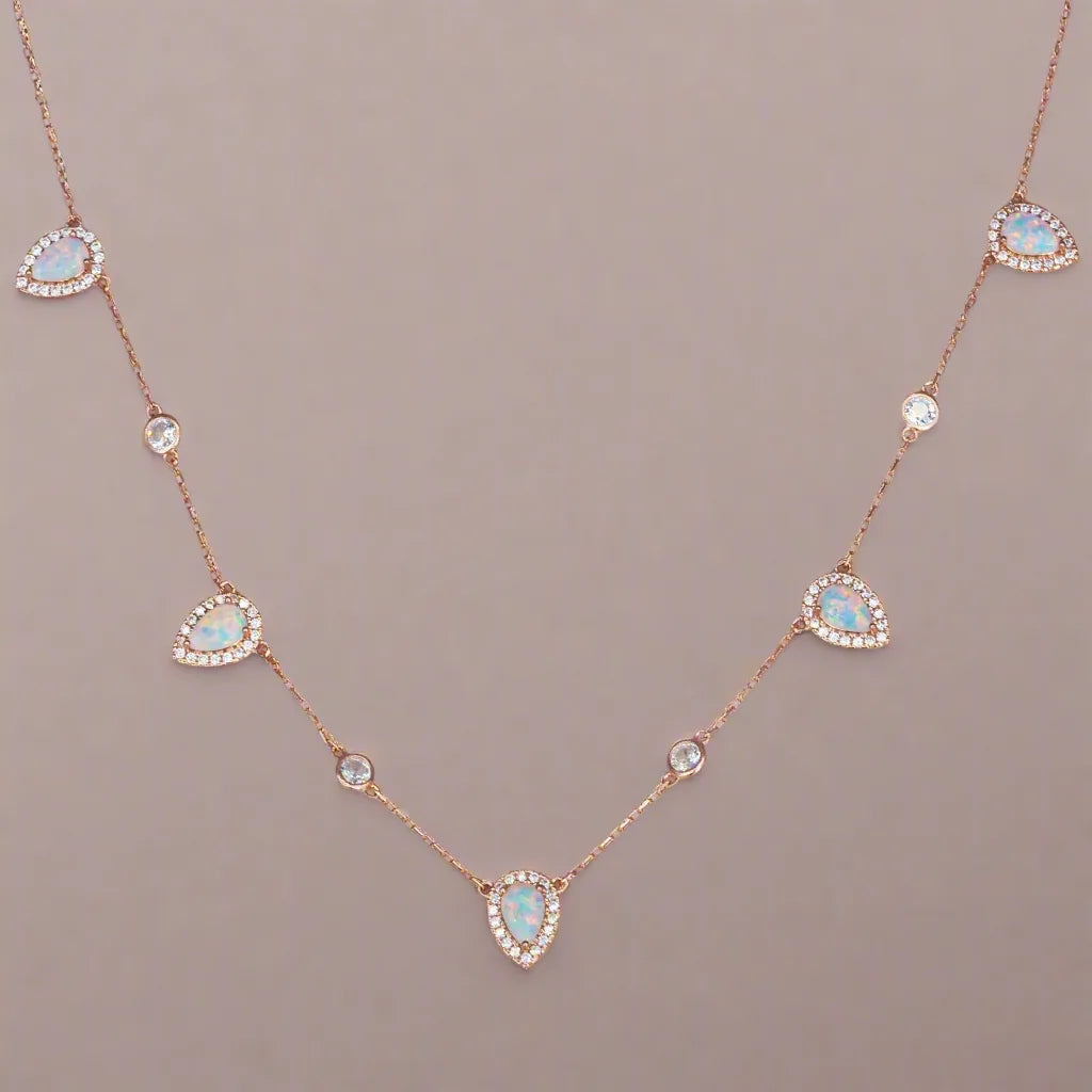Necklace with opal and diamond stones on a beige background