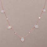 Necklace with opal and diamond stones on a beige background
