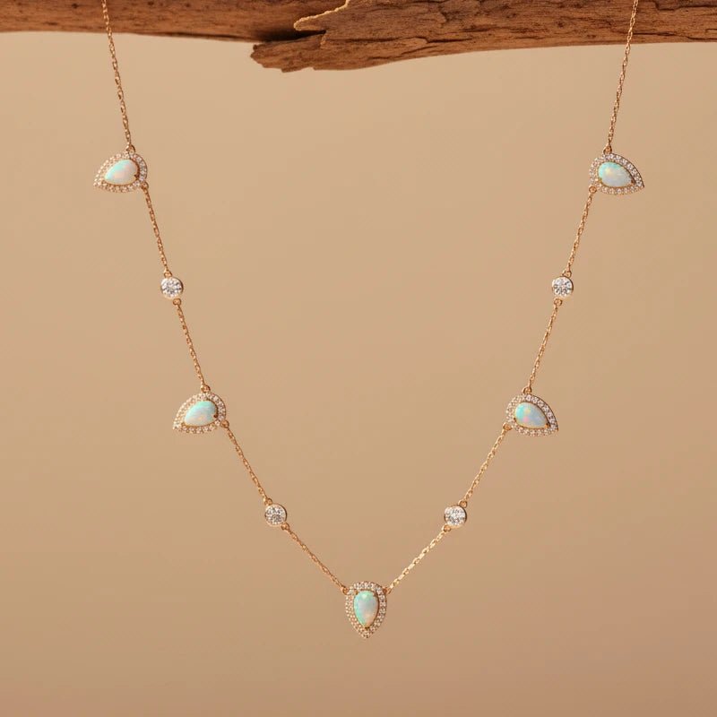 Necklace with opal and diamond stones on a beige background