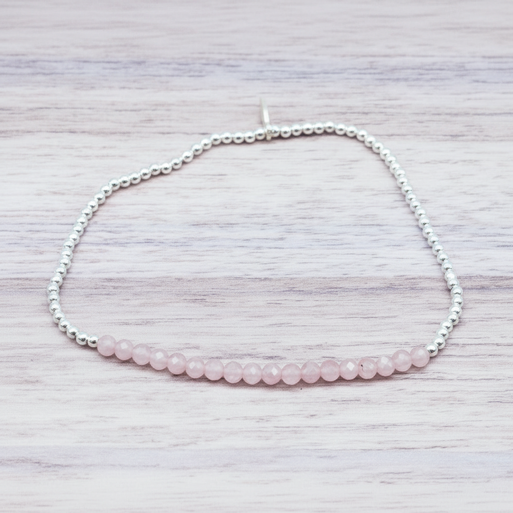 Beaded bracelet with pink beads on a light wooden surface