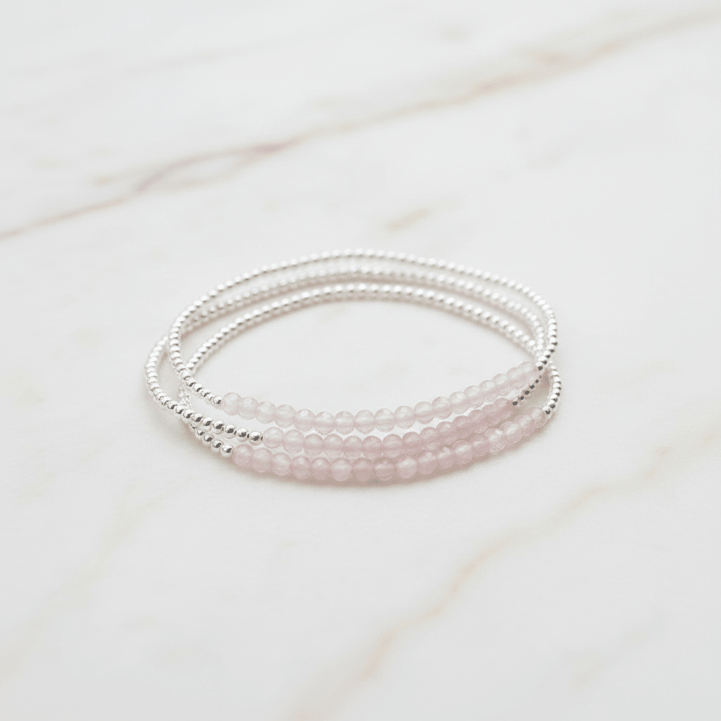 Set of three beaded bracelets on a marble surface