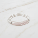 Set of three beaded bracelets on a marble surface