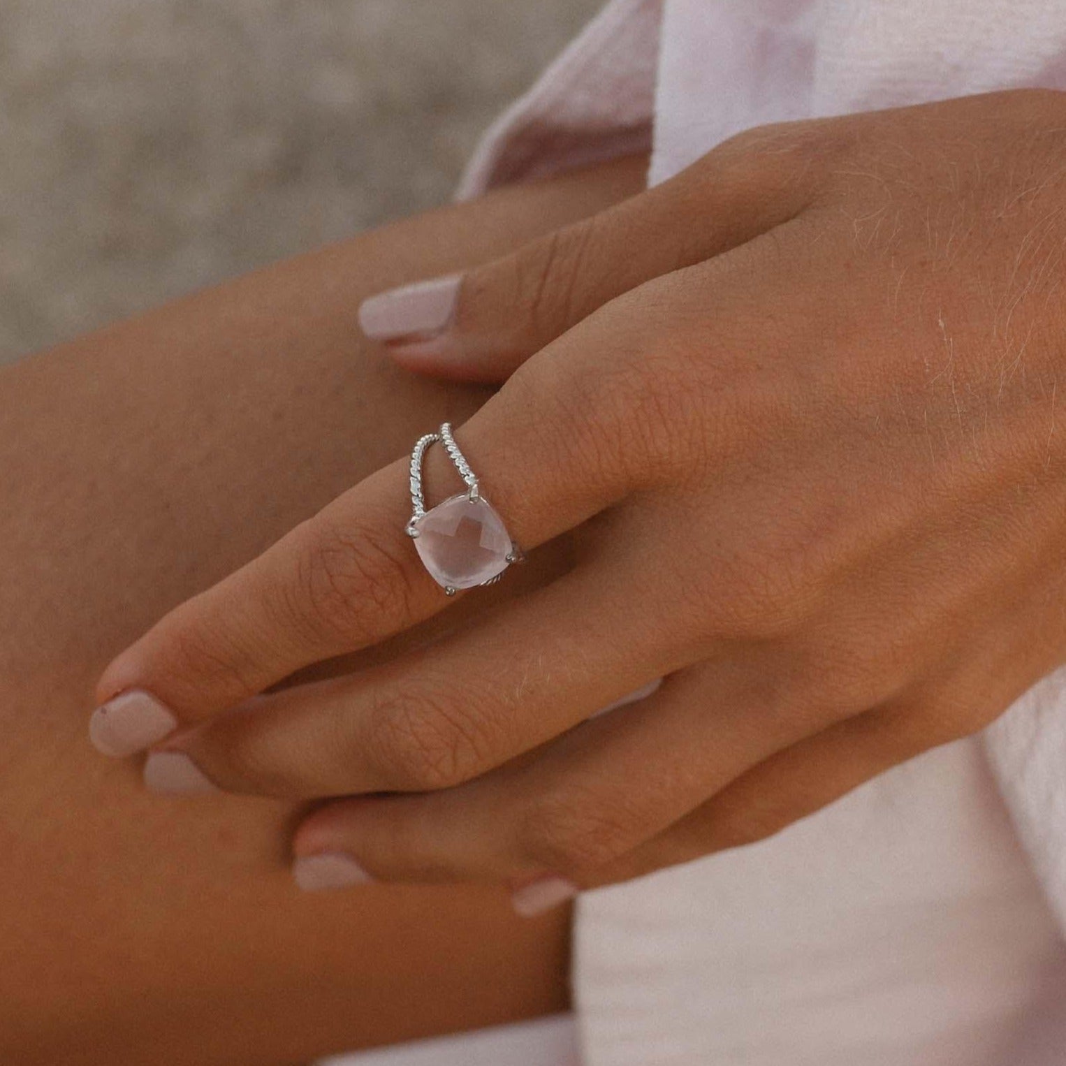 Woman wearing a sterling silver rose quartz ring by Indie and Harper Australia 