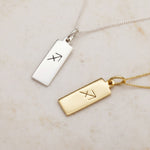 Sagittarius Zodiac Necklaces in Silver and Gold on a warm stone surface