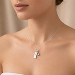 Sterling Silver necklace with a sagittarius zodiac pendant and a November birthstone topaz pendant being worn